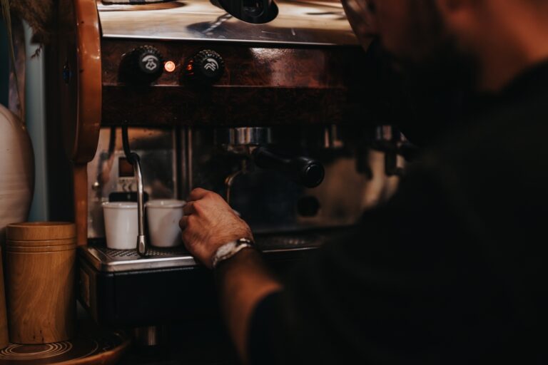 a,barista,operates,an,espresso,machine,to,prepare,fresh,coffee