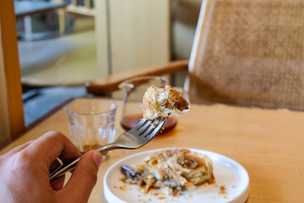 a,person,holding,a,fork,with,a,piece,of,cromboloni
