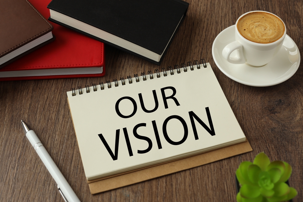 text,our,vision,,on,paper.,potted,plant,next,to,notebook